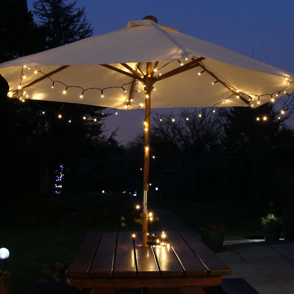 ConnectGo Connectable Solar Fairy Lights in warm white on garden umbrella