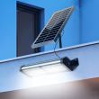 40W Premium Solar Floodlight with ALS Technology – 6000 Lumens showing the lights being used on a modern building with the remote control 