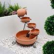 Terracotta Cascade Solar Water Feature - four-tier terracotta bowls on black metal stand shown against white background