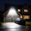 Compact Solar Security Floodlight With Three Adjustable Heads Mounted Above A Back Door Illuminating The Garden Path At Night