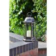 Nordic Candle Lanterns in garden flower bed
