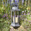 Nordic Candle Lanterns in garden flower bed