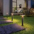 Premium Solar Bollard Lights | Remote Control Pathway Lighting At night highlighting a pathway and a featured rock 