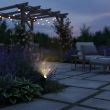 High Lumen 4‑Head Solar Garden Spotlight – Adjustable Outdoor LED In a garden highlighting a lawn area showing the two brightness settings 
