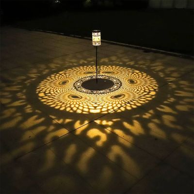 Filigree Solar Stake Lantern – Outdoor Decorative Light showing the Lantern on a spike giving out a beautiful light pattern 