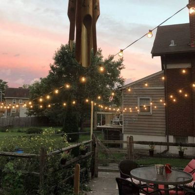 Hybrid Solar & USB‑C Festoon G40 String Lights hung in a back garden using posts for support