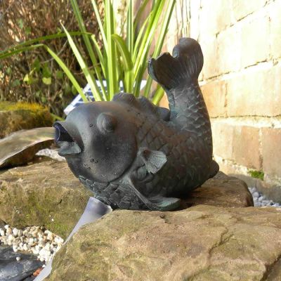 Solar Fish Spitter on side of pond spitting water