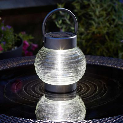 Globe 365 Solar Powered Lantern on garden table at night
