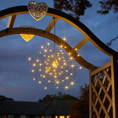 Solar StarBurst Pendant Light night time in warm white hanging in a tree