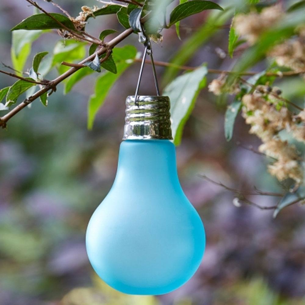 Eureka! Neo Solar Light Bulb - Blue hanging in tree during day time