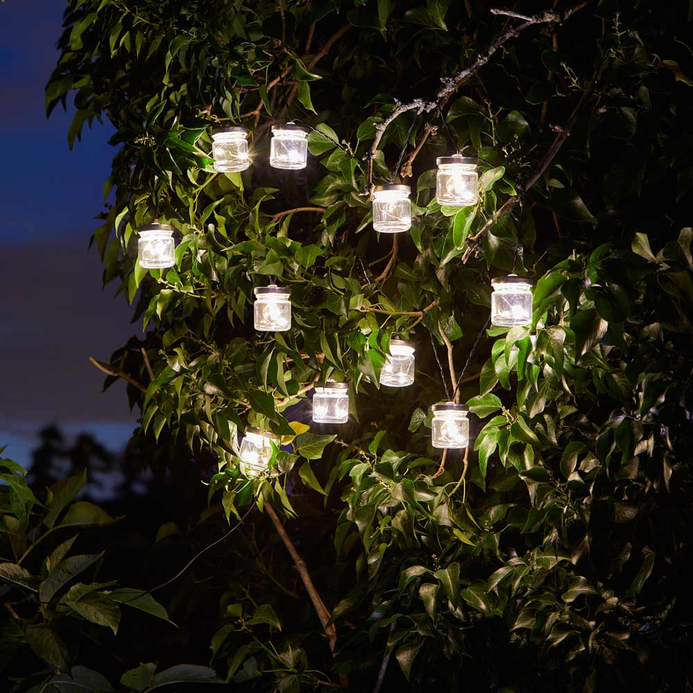 Firefly Jar Solar String Lights hanging in tree at night