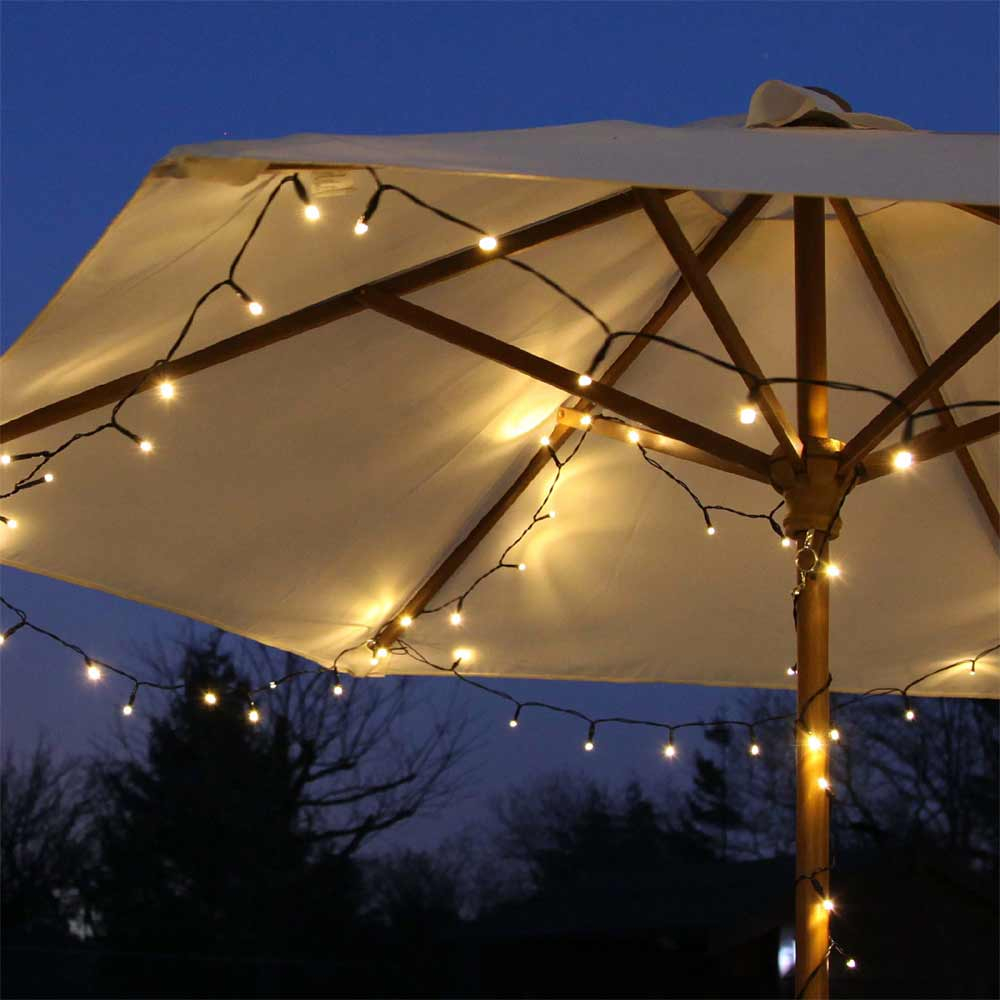 Solar Outdoor Fairy Lights 50 Warm White close up in graden umbrella