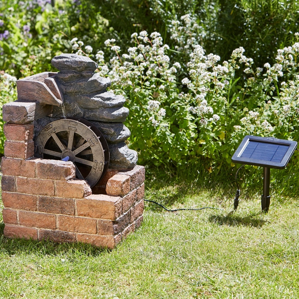 Smart Garden Heywood Mill Solar Resin Fountain in garden with remote solar panel