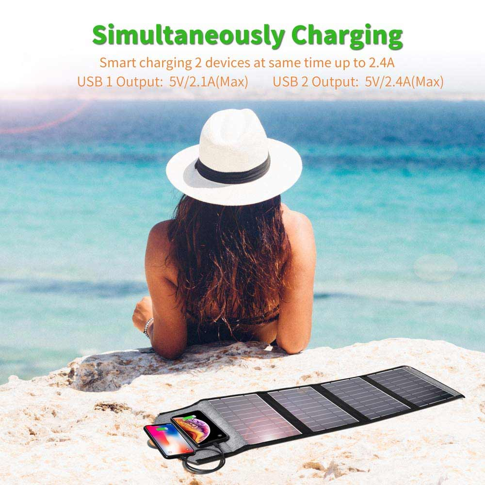 Solar Charger 24w Portable Solar Panel Dual USB Ports being used on beach