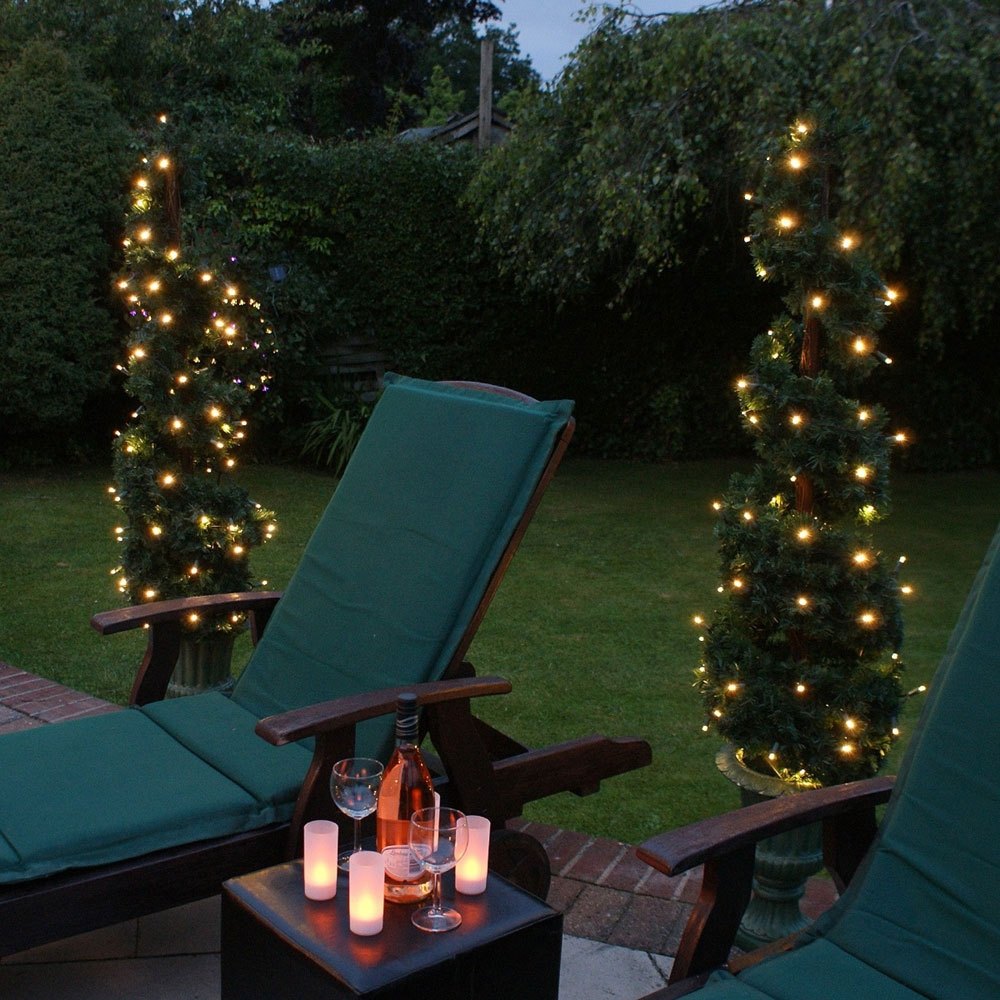 Solar Firefly String Lights 50 Warm White on two conifer trees