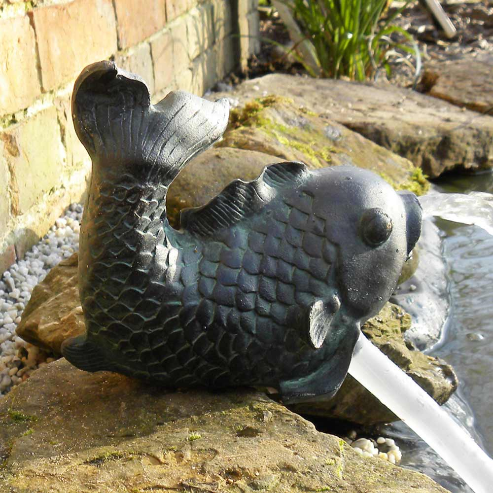 Solar Fish Spitter on side of pond spitting water
