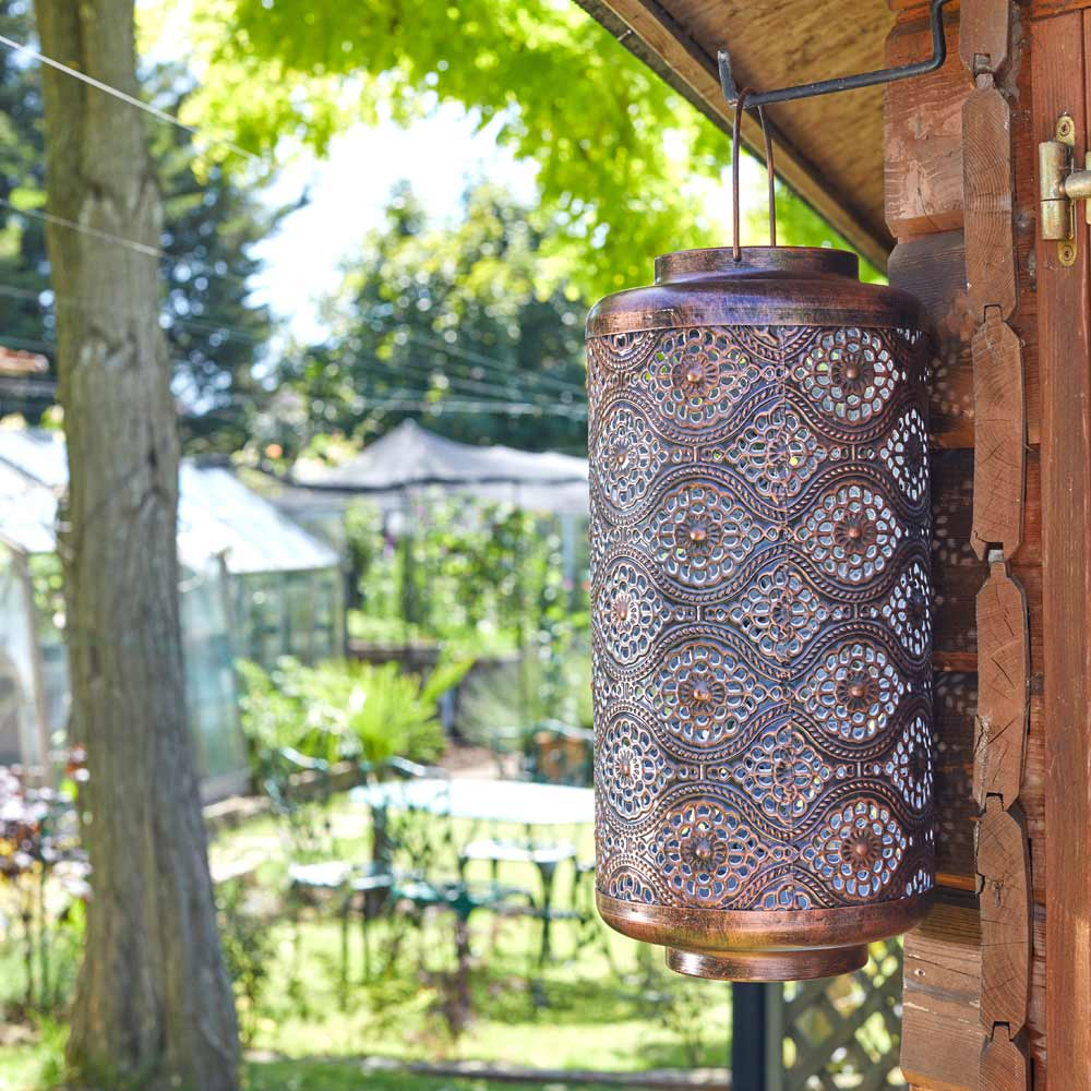 Solar Powered Fez Lantern hanging in garden on shed