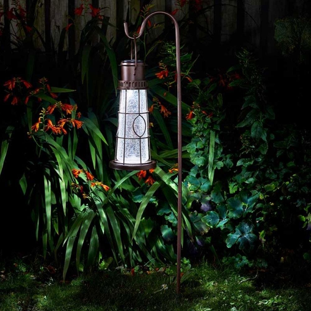 solar powered lighthouse lantern hanging in garden