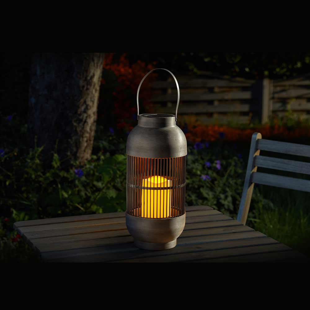 Solar Powered Rivoli Lantern on garden table at night