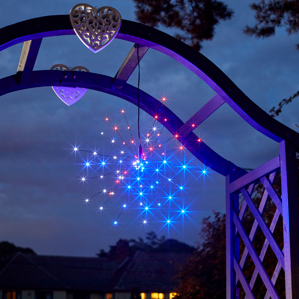 Solar StarBurst Pendant Light night time in multi colour hanging on a garden pergola