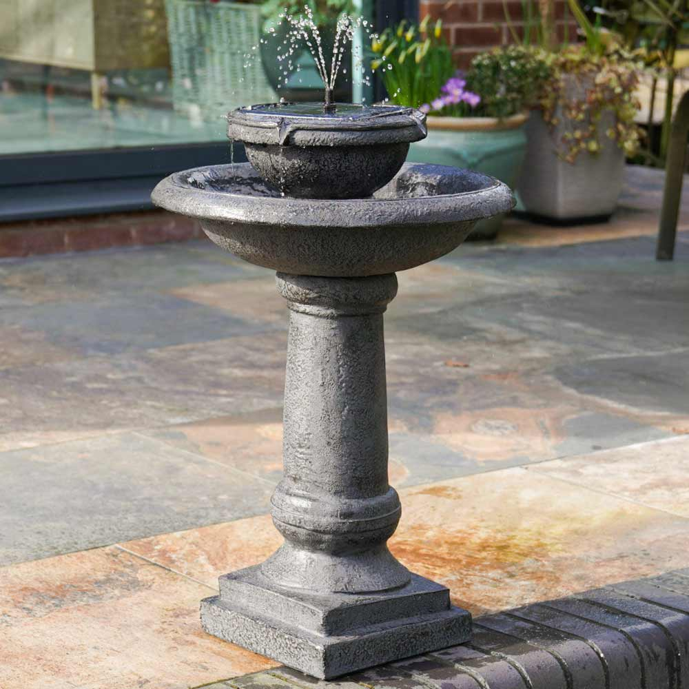 Solar Two-Tiered Pagoda LED Water Feature on patio in garden