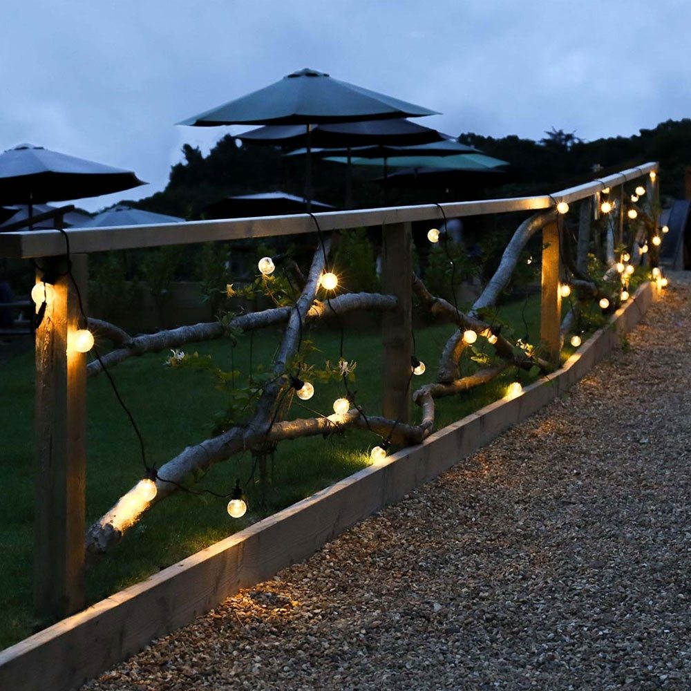 Outdoor Festoon Lights Clear Bulbs Black Cable on wooden fence