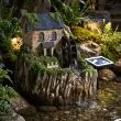 Smart Garden Solar Water Mill Fountain at night time with led lights on