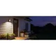 Rechargeable motion sensor light beside a front door at dusk