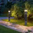 Canterbury bollards beside a building in an illustrative garden setting