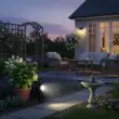 Ultra 365 solar spotlight pair illuminating a lawn at night