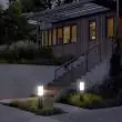 Compact Solar Powered Bollard Style Light - 4 Pack Installed along a pathway in a garden