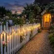 Solar Powered Fairy Lights Wrapped Around A Garden Arch And Trees At Dusk With Warm White Glow Over Patio Furniture
