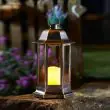 Nordic Candle Lanterns in garden flower bed
