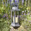 Nordic Candle Lanterns in garden flower bed