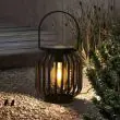 Regatta Outdoor Solar Lanterns showing the solar panel charging and how access the bulb and the carry handle 