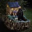 Smart Garden Solar Water Mill Fountain at night time with led lights on