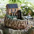 Smart Garden Solar Water Mill Fountain at night time with led lights on