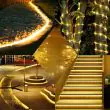 Solar rope lights used to guide a garden pathway, wrapped around trees and installed on patio steps, providing decorative and functional outdoor lighting