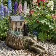 Smart Garden Solar Water Mill Fountain at night time with led lights on