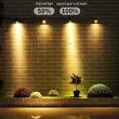 High Lumen 4‑Head Solar Garden Spotlight – Adjustable Outdoor LED In a garden highlighting a lawn area showing the two brightness settings 