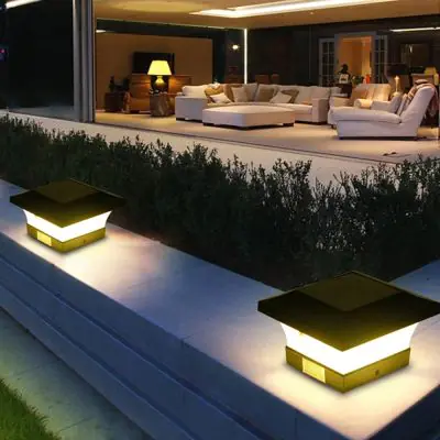 Fence Post Solar Light Caps - 2 Pack installed on a low lying wall in a patio area