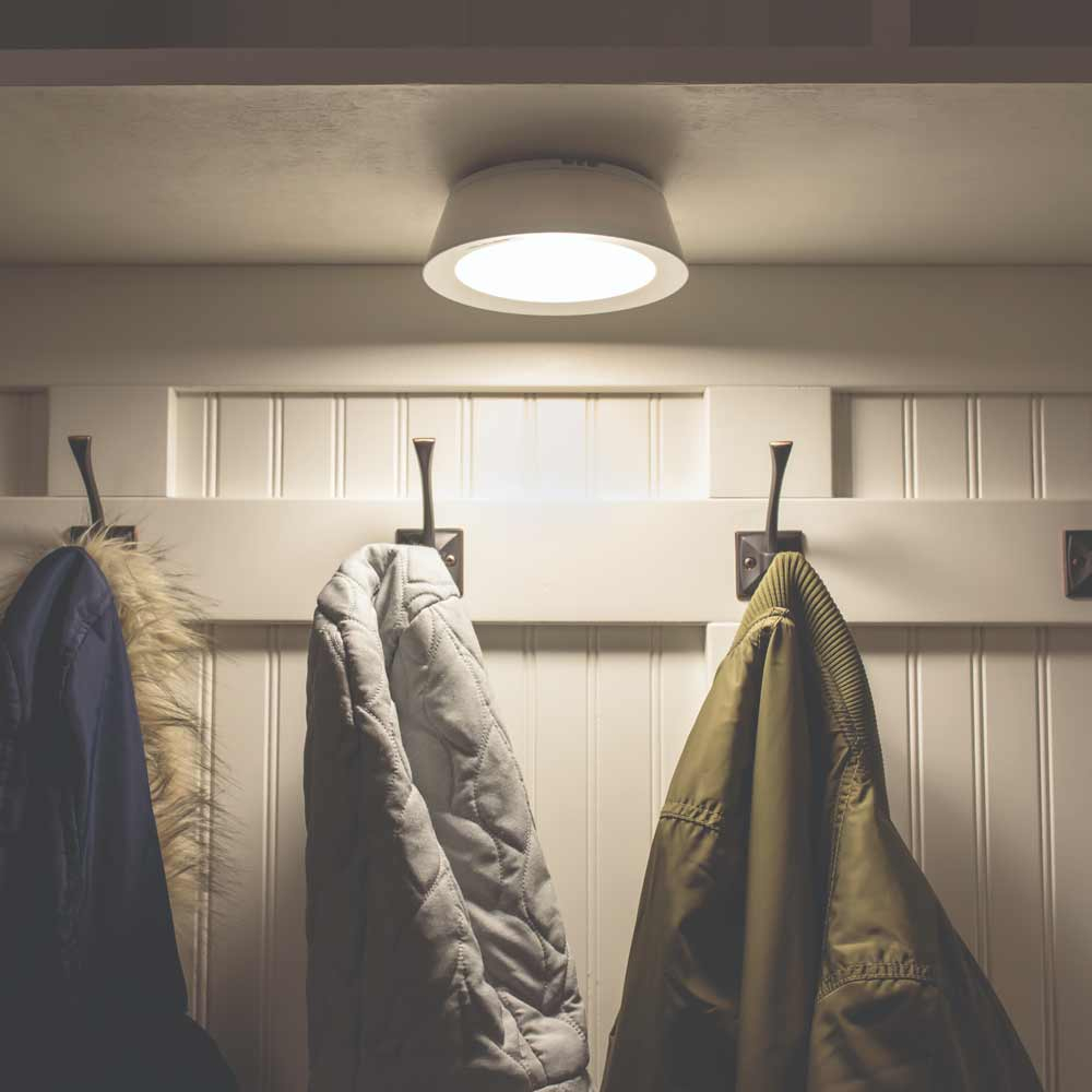 Battery Operated Ceiling Light illuminating coat rack in hallway