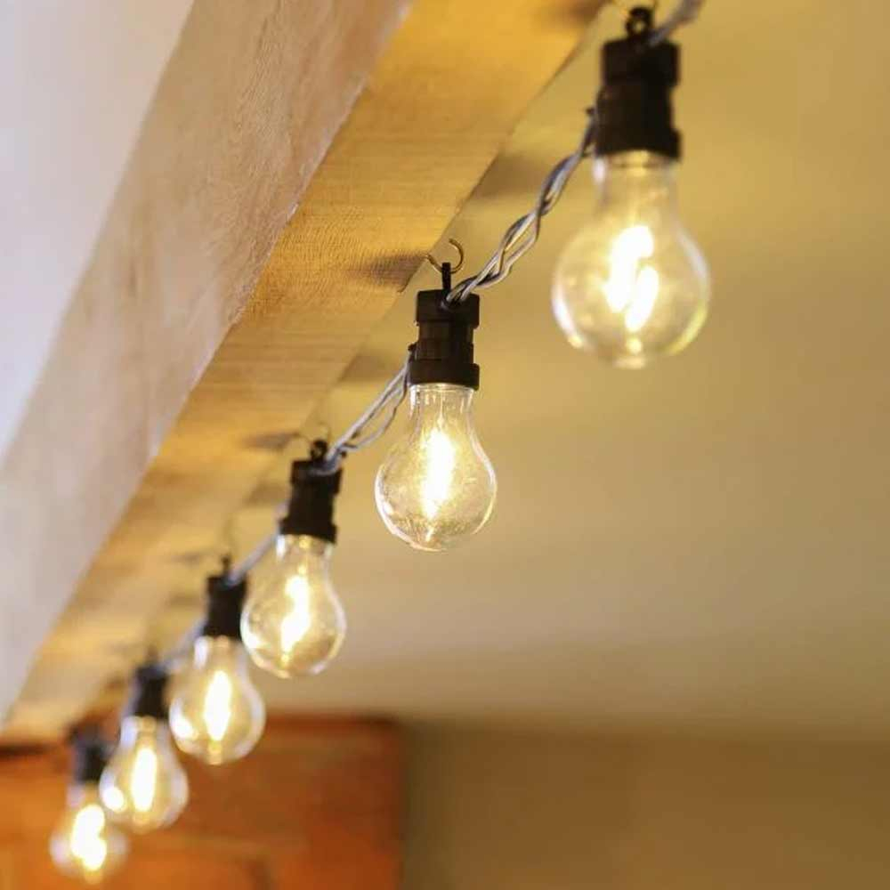 Connectable Festoon Lights turned on along wooden beam